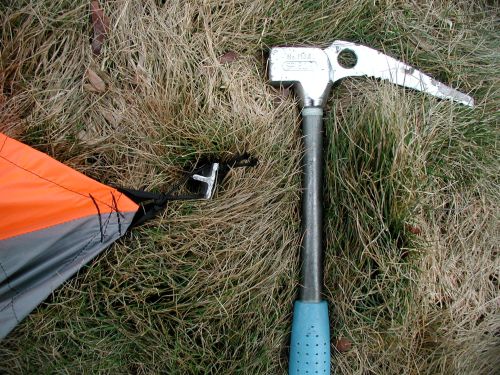 Stake out the four corners. Use a small loop of replaceable cord so wear from rough stake edges will not damage the tent web tie outs.