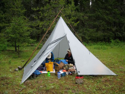 Two wooden poles can be  lasted to hold the tarp up from outside.