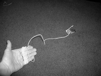 Starting at the bitter end, coil around hand leaving a foot or two  between the hand and tarp attachment point.