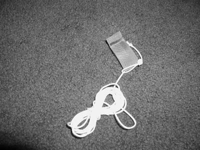 Wrap the remaining cord tightly around the first coil and then pass a loop, close to the tarp attach point, through one end of the now figure eight shape of the coil.