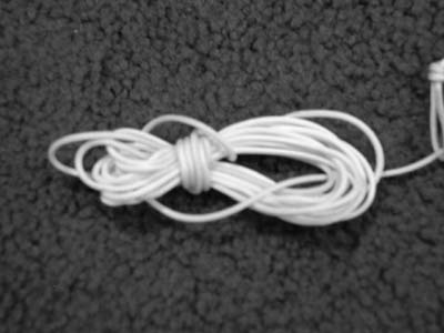 Loop this over the other end of the figure eight and pull. Reverse process when  you need to use the cord to tie up your tarp/tent.