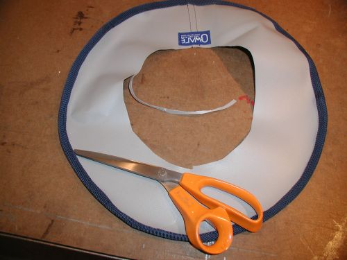 Trim off 1/4 inch all the way around, tapering off as you get to the label in back.